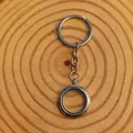 Macro view of a circular silver floating locket keychain on a wooden background. - 25mm / Silver