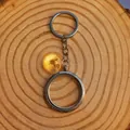 Detailed view of a circular silver floating locket keychain on a wooden base - 38mm / Silver
