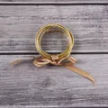 Elegant gold glitter filled silicone bangle bracelet set with a decorative tan ribbon bow - Gold