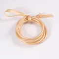 Set di 3 bracciali rigidi glitterati oro champagne con elegante fiocco in nastro di raso - Champagne