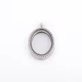 Detailed view of an oval silver floating locket with beaded border design - Silver