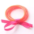 Set di bracciali rigidi in silicone arancione vivace legati con un fiocco decorativo rosa - arancio-rosso