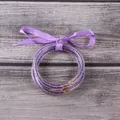 Set of purple glitter-filled silicone bangles tied with a purple ribbon bow detail - 5 Pieces / Light Purple