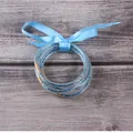 Elegant set of multilayer blue glitter silicone bracelets featuring a light blue ribbon bow - 5 Pieces / Light Blue