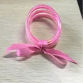 Multi-layered pink glitter silicone bangle set with a matching silk ribbon bow for women - 5 Pieces / Pink