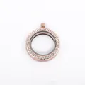 Macro view of the rose gold round locket pendant with sparkling crystal embellishments. - Rose Gold