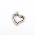 Detail view of a gold heart-shaped floating locket pendant with crystal pavé edging - Rose Gold