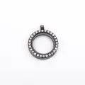Macro view of a gunmetal round glass locket pendant decorated with sparkling rhinestones - Black