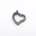 Macro detail of heart-shaped black metal floating locket with rhinestones and glass - Rhinestone Inlaid Heart Pendant (ML45) / Black