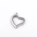 Close-up view of a heart-shaped silver floating locket pendant with sparkly rhinestones - Silver