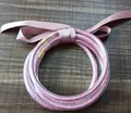 Multi-layer pink glitter filled silicone bangles set decorated with a matching satin ribbon bow - Pink