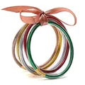 Multi-layered glitter filled silicone bracelets set with a ribbon bow on white background. - Multicolor