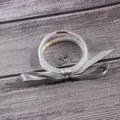 Detailed view of five-layer glitter silicone jelly bangles tied with a stylish grey ribbon - 5 Piece Set / Silver