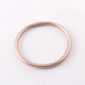Close-up detail of a shiny rose gold silicone bracelet with a smooth metallic finish - Champagne Gold