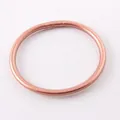 Detailed close-up of a glitter-infused rose gold silicone bangle with smooth surface - 63mm / Rose Gold