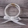 Close-up detail of three-layer silicone glitter jelly bangles with a white satin ribbon bow - 3-Layer Set / White