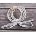 Detailed close-up of 7-piece white glitter jelly bangles tied with a silk ribbon bow - White