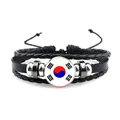 Detail des südkoreanischen Flaggenarmbands mit Ledergeflecht und Taegeukgi-Glaskabochon - Druckknopf Leder Stil