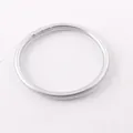 Detail view of a minimalist silver shiny silicone bangle with a sleek circular design - 63mm / Silver