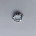 Close-up of a circular transparent stainless steel Gawu box pendant - Transverse Ring (Mini) / 6x20mm / Steel