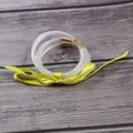 Macro detail view of three shimmering glitter silicone jelly bangles with a yellow ribbon bow - 5 Piece Set / Yellow