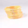 Close-up of yellow PVC jelly bangles filled with sparkling gold glitter, set of 12. - 9 Pieces Set / Old Yellow