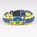 Detail view of a yellow and blue paracord survival bracelet with Ukraine coat of arms - Ukraine Flag