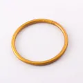 Close-up of a minimalist golden glitter silicone bangle bracelet with a smooth finish - Antique Gold