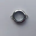 Macro view of a circular transparent silver Gau box locket with dual connection rings - Transverse Ring (Small) / 6x25mm / Steel