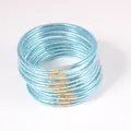 Macro detail of blue glitter filled PVC jelly bangles in a set of 12 pieces. - Set of 12 / Teal