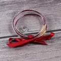 Detail view of three-layer red rhinestone silicone bangles with a satin ribbon knot. - 3-Layer Set / January Red