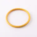 Detail shot of a shiny golden foil silicone bangle bracelet with a metallic finish - 63mm / Gold