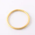 Detailed macro view of a flexible shiny gold foil silicone bangle bracelet for women. - 63mm / Light gold