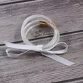 Close-up detail of five glitter-filled silicone jelly bangles with white ribbon - 5 Piece Set / White
