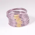 Close-up of stacked purple glitter jelly bangles with gold connectors. - 9 Pieces Set / Mixed Purple