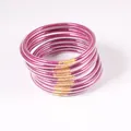 Detail view of a 12-piece set of purple glitter jelly bangles in soft PVC material - 9 Pieces Set / Magenta