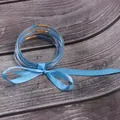 Close-up of 5-layer blue silicone jelly bangles with beads and a satin ribbon bow. - 5 Pieces / Light Blue