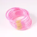 Macro view of pink glitter jelly bangles with gold connectors in a set of 12 pieces - 9 Pieces Set / Deep Pink