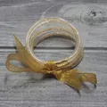 Juego de cinco pulseras de silicona con purpurina dorada y lazo decorativo - Dorado
