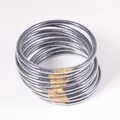 Detailed macro view of twelve silver glitter jelly bangles with gold metal connectors. - 9 Pieces Set / Dark Gray