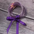 Detail view of 7 layers purple silicone glitter jelly bangles with a matching silk ribbon - Purple