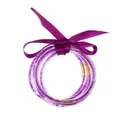 Close-up of five-layer purple glitter silicone bangles with a satin ribbon bow - February