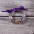Set of five glitter filled silicone jelly bangles featuring a purple decorative ribbon bow - 5 Pieces / Mixed Purple