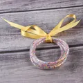 Set of five glitter jelly bangles with stars and a decorative yellow ribbon bow - 5 Pieces / Star Mixed