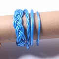 Close-up of four metallic blue jelly bangles with braided and twisted textures - Set of 4 / Sky Blue