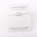 Bracelet puzzle pour la sensibilisation à l'autisme avec message sur carte blanche - Blanc