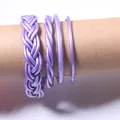 Detail showing 4-piece set of purple jelly bangles with braided and smooth designs. - Set of 4 / Light Purple