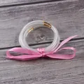 Set of three silver glitter clear jelly bangles with a decorative pink ribbon tie. - 5 Piece Set / Pink