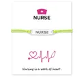 Detailed close-up view of the 'NURSE' engraved cord bracelet on a heart-themed card - Green
