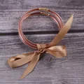 Lot de trois joncs en silicone pailleté avec un ruban de satin couleur bronze - Ensemble à 3 couches / Or rose